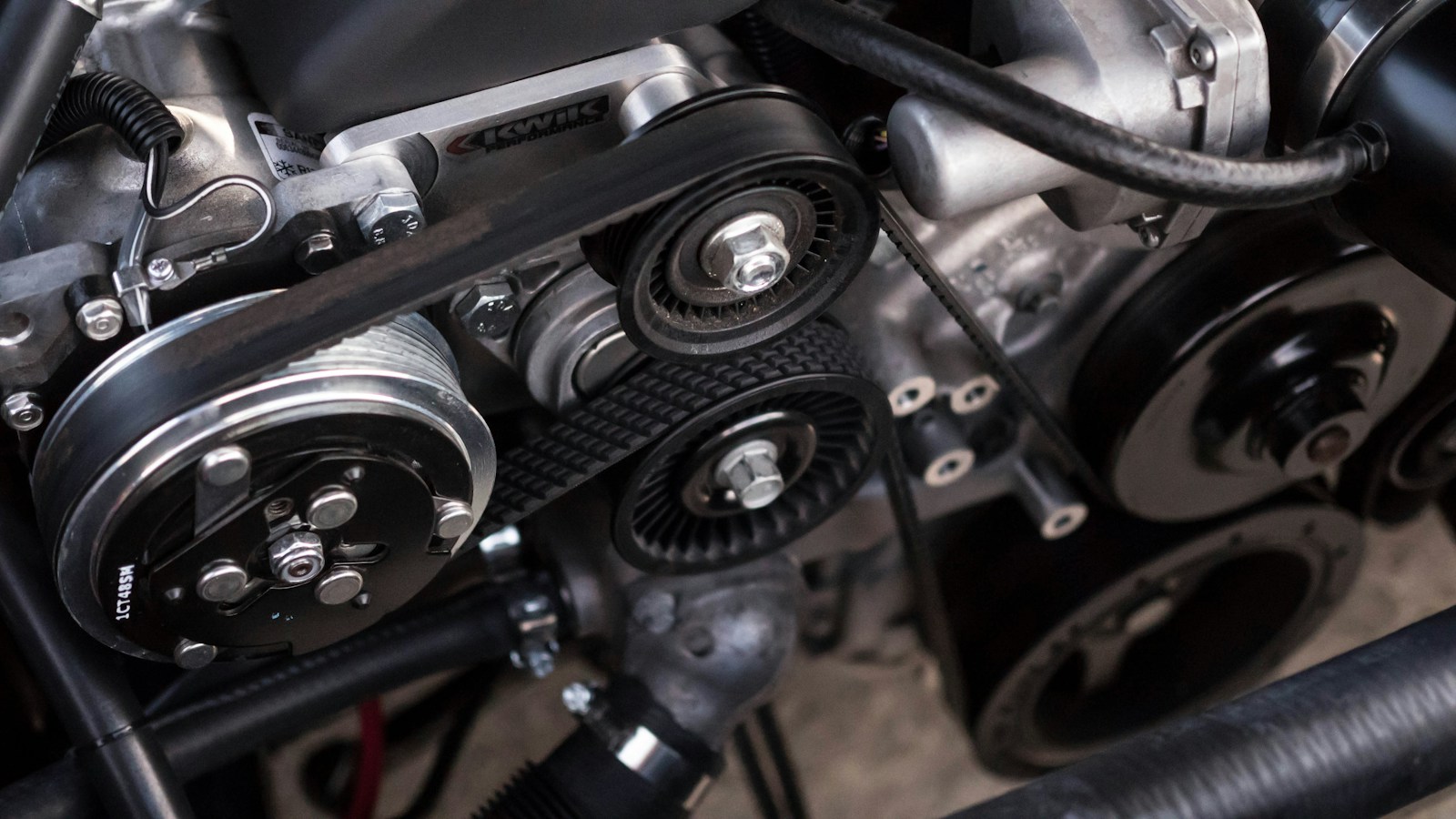 Close-up photograph of an automotive engine and belt system